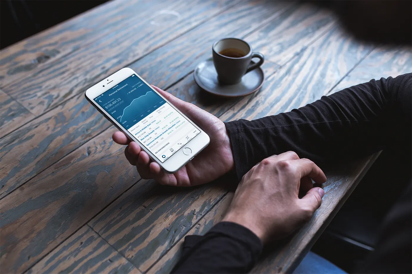 The T. Rowe Price app held in a hand